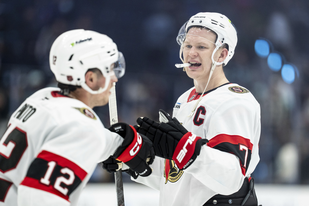 Ottawa Senators forward Brady Tkachuk, right, and forward Shane Pinto celebrate after an NHL hockey game against the Seattle Kraken Saturday, March 7, 2026, in Seattle. (AP Photo/Stephen Brashear)