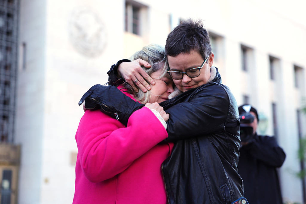 Lennon Flowers, right, Project Director of The Parents' Network hugs Lori Schott, mother of Annalee Schott, outside a landmark trial over whether social media platforms deliberately addict and harm children, Wednesday, Feb. 18, 2026, in Los Angeles. (AP Photo/Ryan Sun)