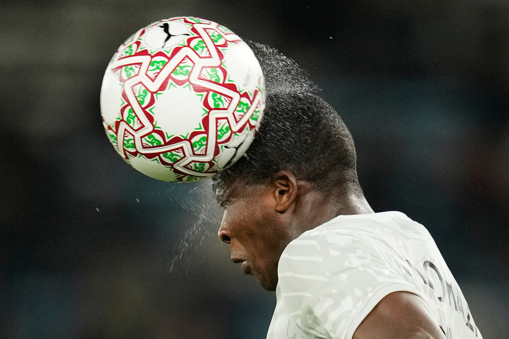 South Africa's Mbekezeli Mbokazi heads the wet ball during the Africa Cup of Nations round of 16 soccer match between South Africa and Cameroon in Rabat, Morocco, Sunday, Jan. 4, 2026. (AP Photo/Themba Hadebe)