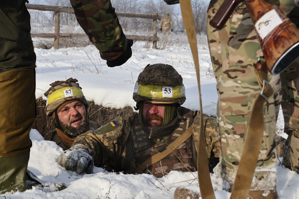 In this photo provided by Ukraine's 65th Mechanized Brigade press service, recruits perform drills at a training ground in the Zaporizhzhia region, Ukraine, Thursday, Jan. 1, 2026. (Andriy Andriyenko/Ukraine's 65th Mechanized Brigade via AP)