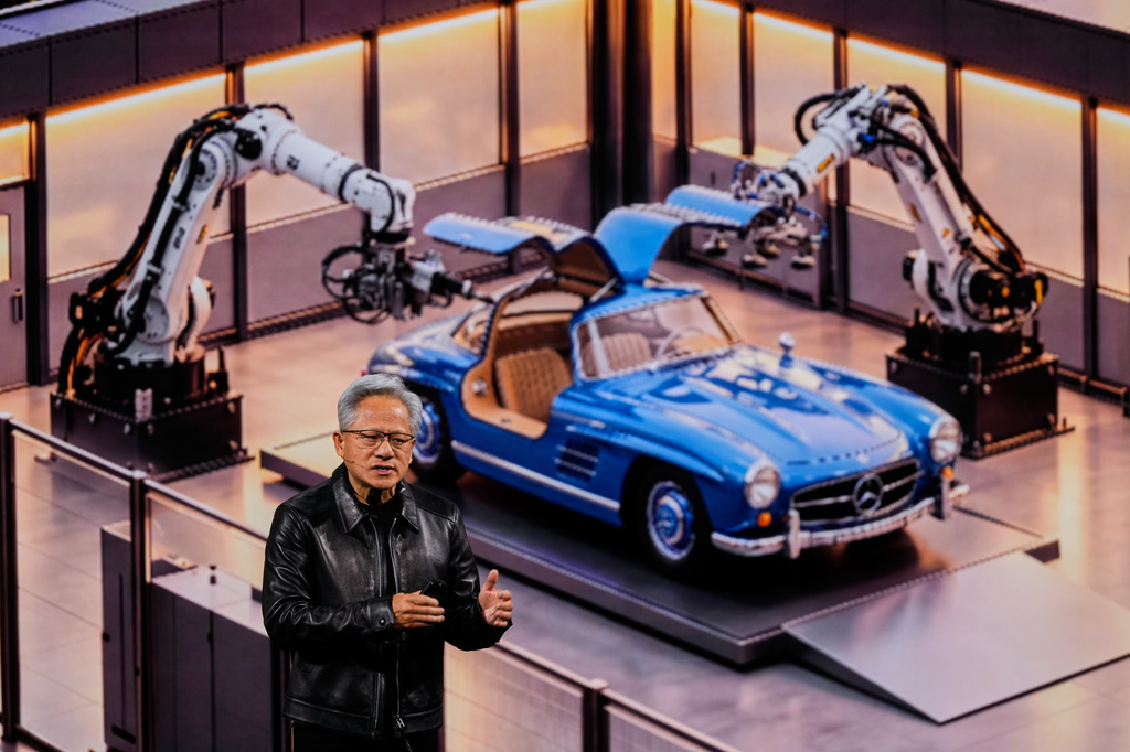 Nvidia CEO Jensen Huang stands near a Mercedes car as he delivers his keynote on the company's GTC event in Berlin, Germany, Wednesday, Oct. 21, 2026. (AP Photo/Markus Schreiber)