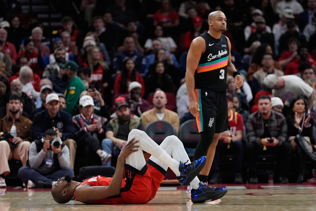 Houston Rockets forward Kevin Durant (7) reacts after a collision with San Antonio Spurs forward Keldon Johnson (3) during the first half of an NBA basketball game in Houston, Tuesday, Jan. 20, 2026. (AP Photo/Ashley Landis)