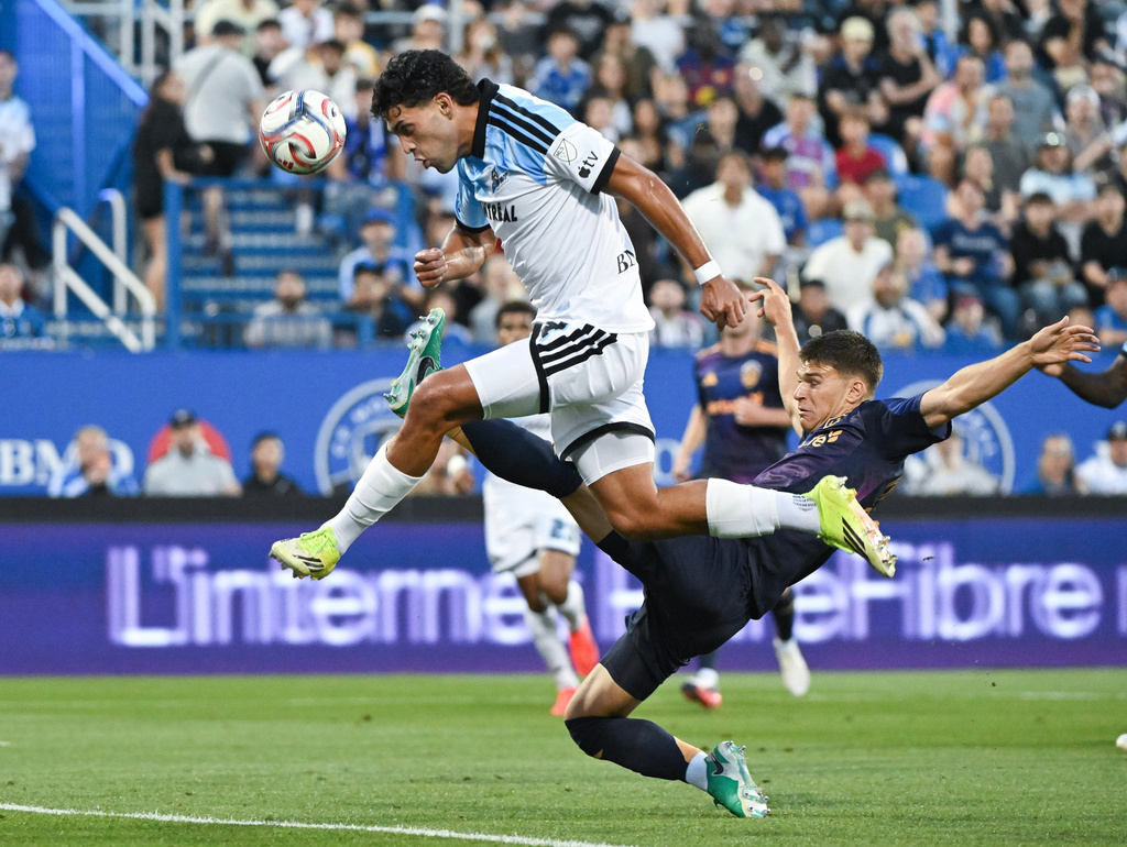 LA Galaxy's Harbor Miller, right, defends against CF Montreal's Daniel Rios during the first half MLS soccer game in Montreal, Saturday, Aug. 22, 2026. (Graham Hughes/The Canadian Press via AP)