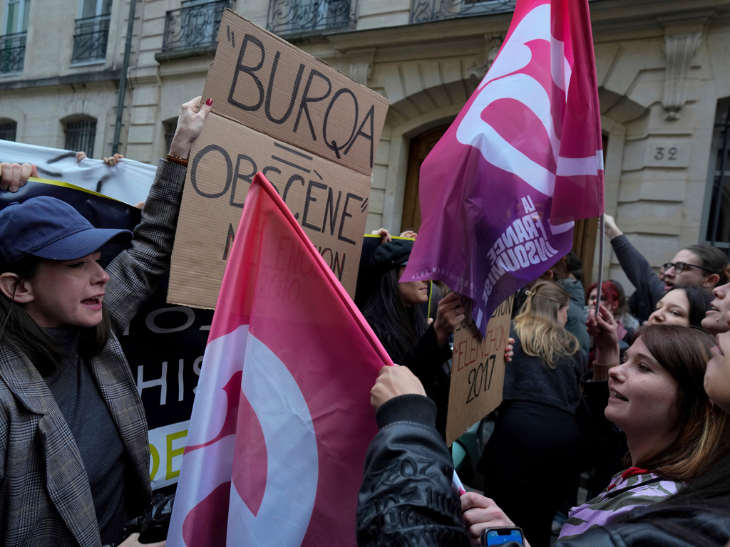 FILE- Founder of feminist group 'Nemesis', Alice Cordier, left, faces supporters of far-left party La France Insoumise (LFI) as she protests against a conference given by far-left politician Jean-Luc Melenchon, unseen, as part of the European elections campaign, at the University of Sciences Politiques, in Paris, Monday, April 22, 2024. (AP Photo/Thibault Camus, File)