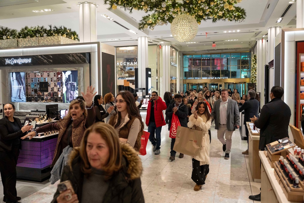Customers walk into Macy's flagship store, Friday, Nov. 21, 2025, in New York. (AP Photo/Yuki Iwamura)