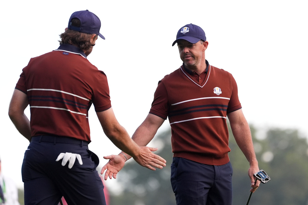 Europe's Tommy Fleetwood celebrates with Rory McIlroy on the third hole at Bethpage Black golf course during the Ryder Cup golf tournament, Saturday, Sept. 27, 2025, in Farmingdale, N.Y. (AP Photo/Lindsey Wasson)