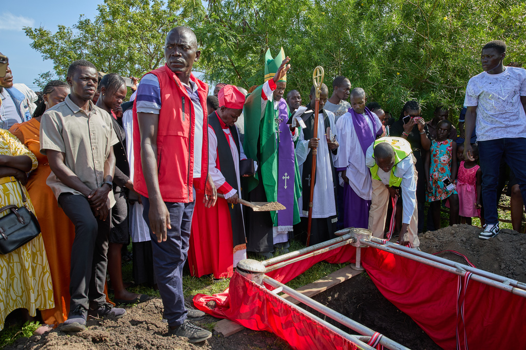 Clergy members and mourners gather during the burial of Tom Ochieng Mima on the outskirts of Kisumu, Kenya, Friday, March 13, 2026. (AP Photo/Asa Wallin)