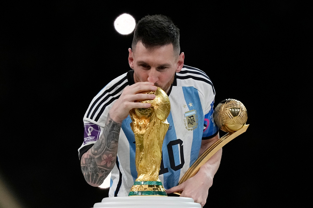 FILE - Argentina's Lionel Messi kisses the trophy after winning the World Cup final soccer match between Argentina and France in Lusail, Qatar, Dec. 18, 2022. Argentina won 4-2 in a penalty shootout after the match ended tied 3-3. (AP Photo/Martin Meissner, File)