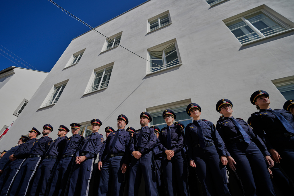 Austrian police officers stand in front of a new police station which is located in Adolf Hitler's birth house in Braunau am Inn, Austria, Wednesday, July 22, 2026. (AP Photo/Matthias Schrader)