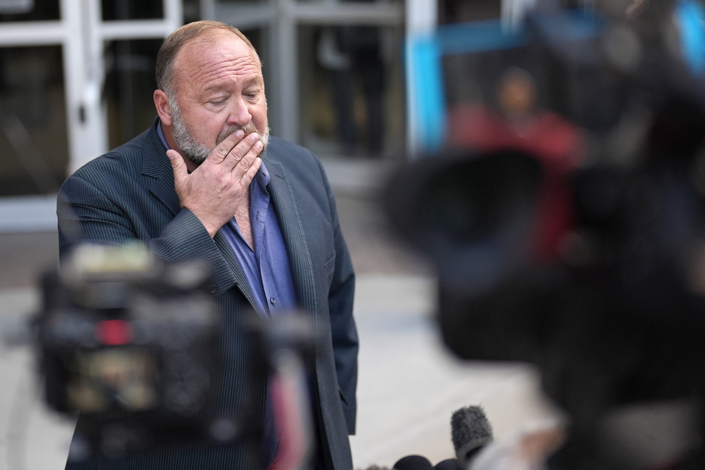 FILE - Alex Jones pauses before speaking to the media after arriving at the federal courthouse for a hearing in front of a bankruptcy judge, June 14, 2024, in Houston. (AP Photo/David J. Phillip, file)
