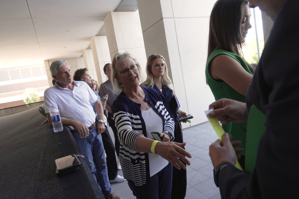 People receive wristbands to access limited public seating available at a preliminary hearing for Tyler Robinson, the Utah man accused of fatally shooting Charlie Kirk, in Provo, Utah, Wednesday, July 8, 2026. (AP Photo/Ty ONeil)