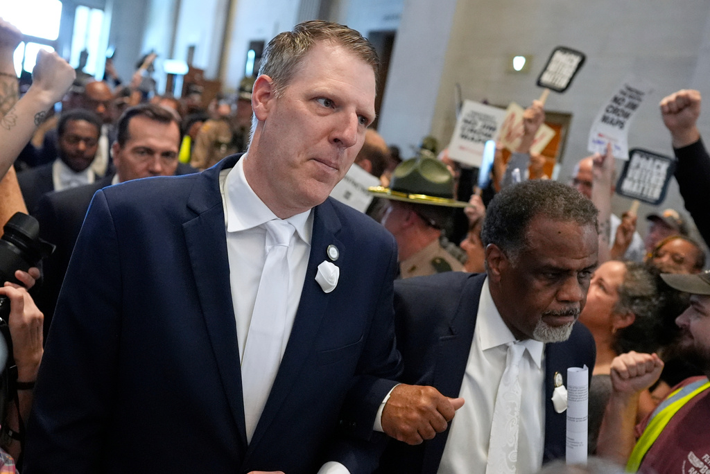Rep. Caleb Hemmer, D-Nashville, and Rep. Sam McKenzie, D-Knoxville, walk to the House chamber arm in arm for a special session of the state legislature to redraw U.S. Congressional voting maps Thursday, May 7, 2026, in Nashville, Tenn. (AP Photo/George Walker IV)