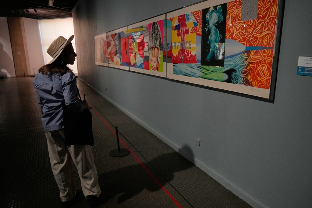Iranian Artist Ghazaleh Jahanbin looks at "F-111" an artwork of American artist James Rosenquist as she visits an exhibition called: "Art & war" displaying some artworks of American pop artists at the Tehran Museum of Contemporary Art in Iran, Thursday, May 7, 2026. (AP Photo/Vahid Salemi)
