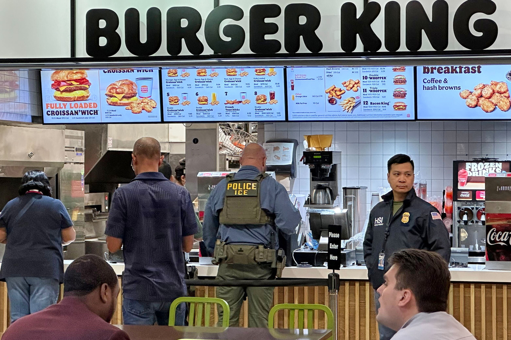 Federal immigration agents are seen at the Hartsfield-Jackson Atlanta International Airport, Monday, March 23, 2026, in Atlanta. (AP Photo/Emilie Megnien)