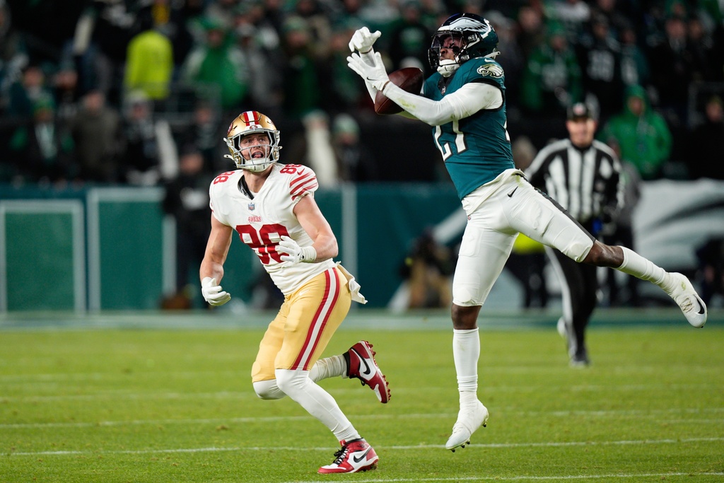 Philadelphia Eagles cornerback Quinyon Mitchell (27) intercepts a pass intended for San Francisco 49ers tight end Jake Tonges (88) during the second half of an NFL wild-card playoff football game Sunday, Jan. 11, 2026, in Philadelphia. (AP Photo/Chris Szagola)