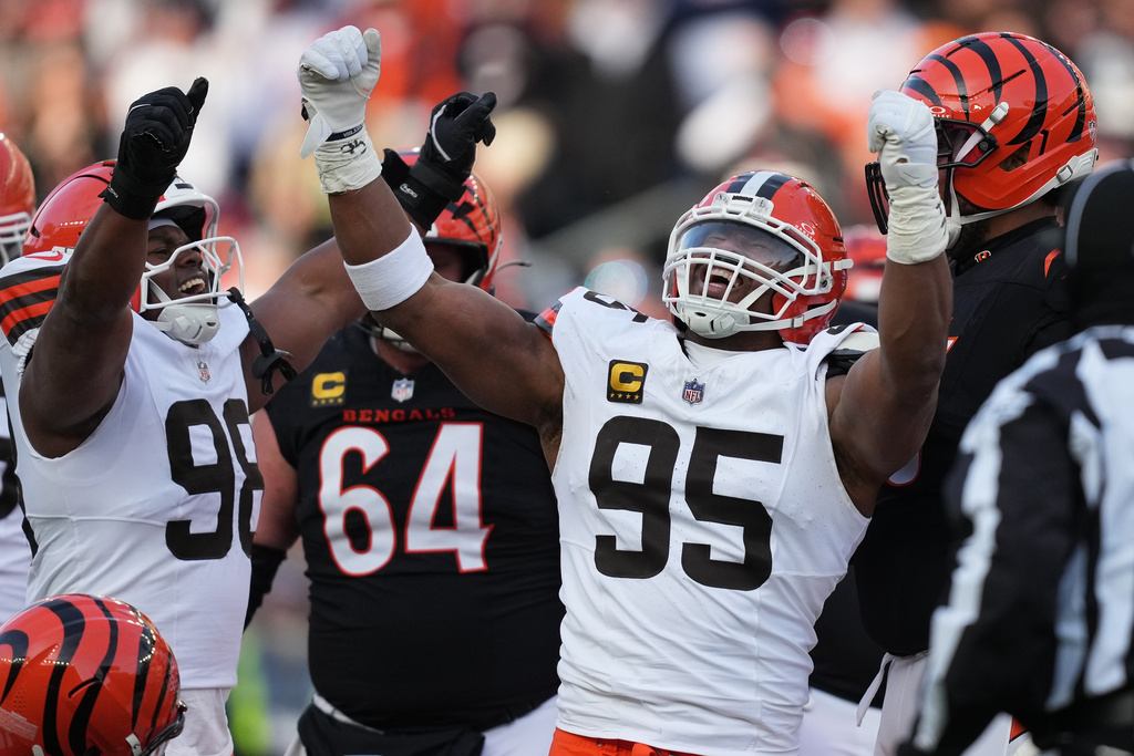 Cleveland Browns defensive end Myles Garrett (95) celebrates with defensive end Adin Huntington (98) after sacking Cincinnati Bengals quarterback Joe Burrow to set an NFL record for sacks in the regular season during the second half of an NFL football game, Sunday, Jan. 4, 2026, in Cincinnati. (AP Photo/Joshua A. Bickel)
