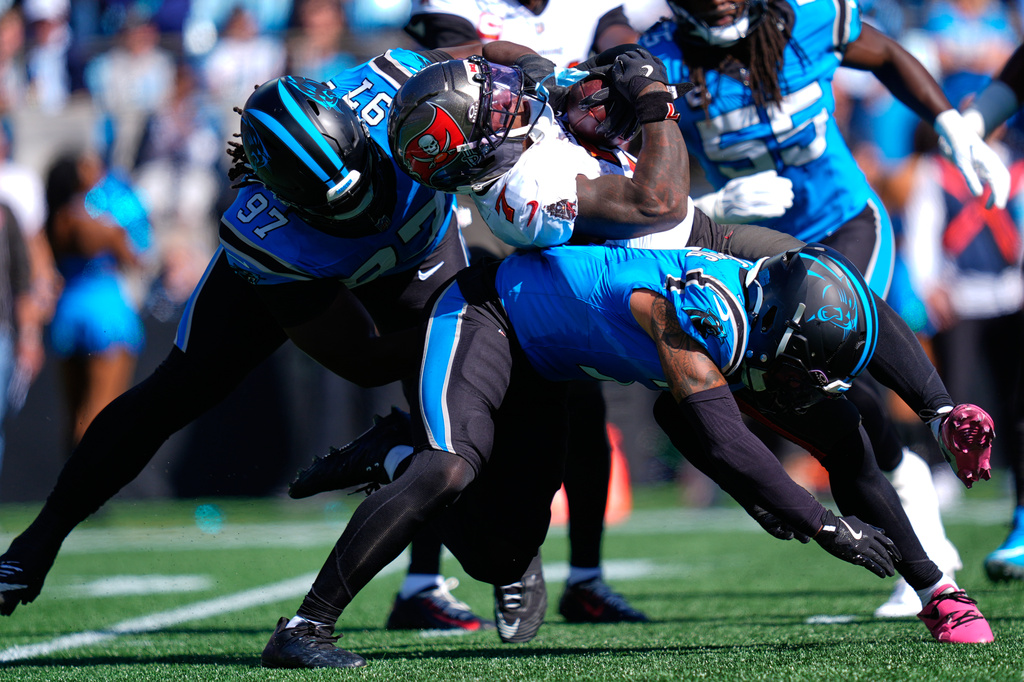 Carolina Panthers' Bobby Brown III (97) tackles Tampa Bay Buccaneers' Bucky Irving (7) during the first half of an NFL football game in Charlotte, N.C., Sunday, Oct. 25, 2026. (AP Photo/Erik Verduzco)