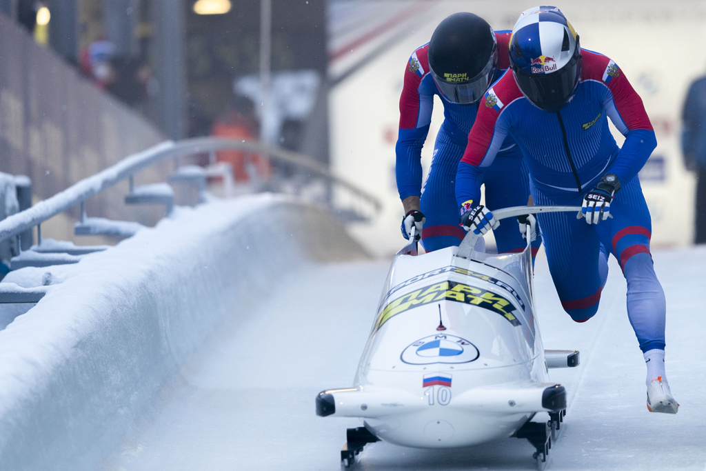 FILE - Rostislav Gaitiukevich and Mikhail Mordasov, from Russia, push at the start of the men's two-man bobsleigh World Cup race in Igls, near Innsbruck, Austria, Saturday, Nov. 27, 2021. (AP Photo/Lisa Leutner, File)