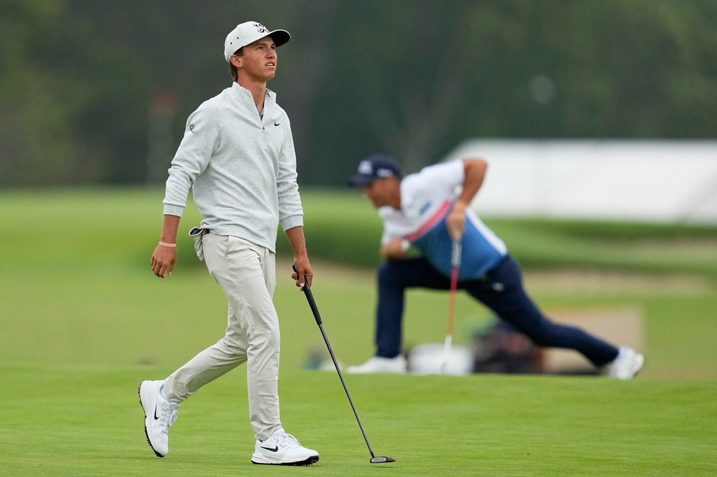 Padraig Harrington, of Ireland, and Miles Russell play on the first hole during the first round of the U.S. Open golf tournament at Shinnecock Hills Golf Club in Southampton, N.Y., Thursday, June 18, 2026.(AP Photo/David J. Phillip)