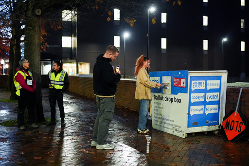FILE - A voter poses for a photo as they place their ballot in a drop box on Election Day, Nov. 5, 2024, in Seattle. (AP Photo/Lindsey Wasson, File) FILE - A voter poses for a photo as they place their ballot in a drop box on Election Day, Nov. 5, 2024, in Seattle. (AP Photo/Lindsey Wasson, File)