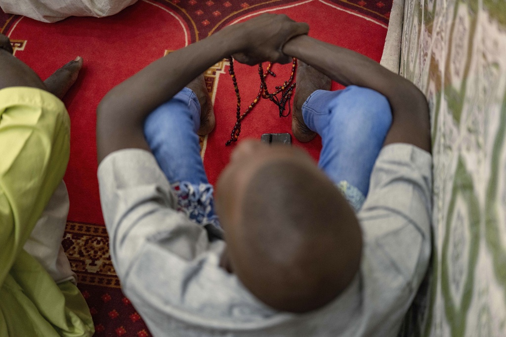 Worshippers listen to Imam Ibrahima Diane, advocate for an end to gender-based violence and practices like female genital mutilation, deliver his sermon at the Great Mosque of Nietty Mbar in Thiaroye, a suburb of Dakar, Senegal, Friday, July 4, 2025.(AP Photo/Sylvain Cherkaoui)