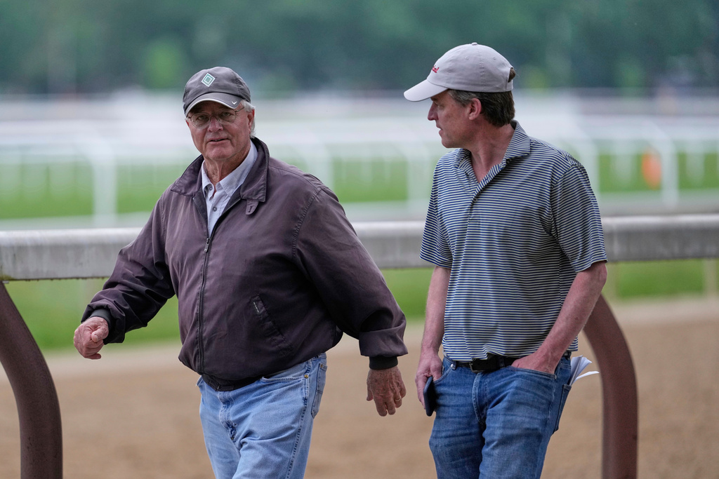 FILE - Trainer Bill Mott, left, walks along the training track in Saratoga Springs, N.Y., June 6, 2025. (AP Photo/Seth Wenig, File)