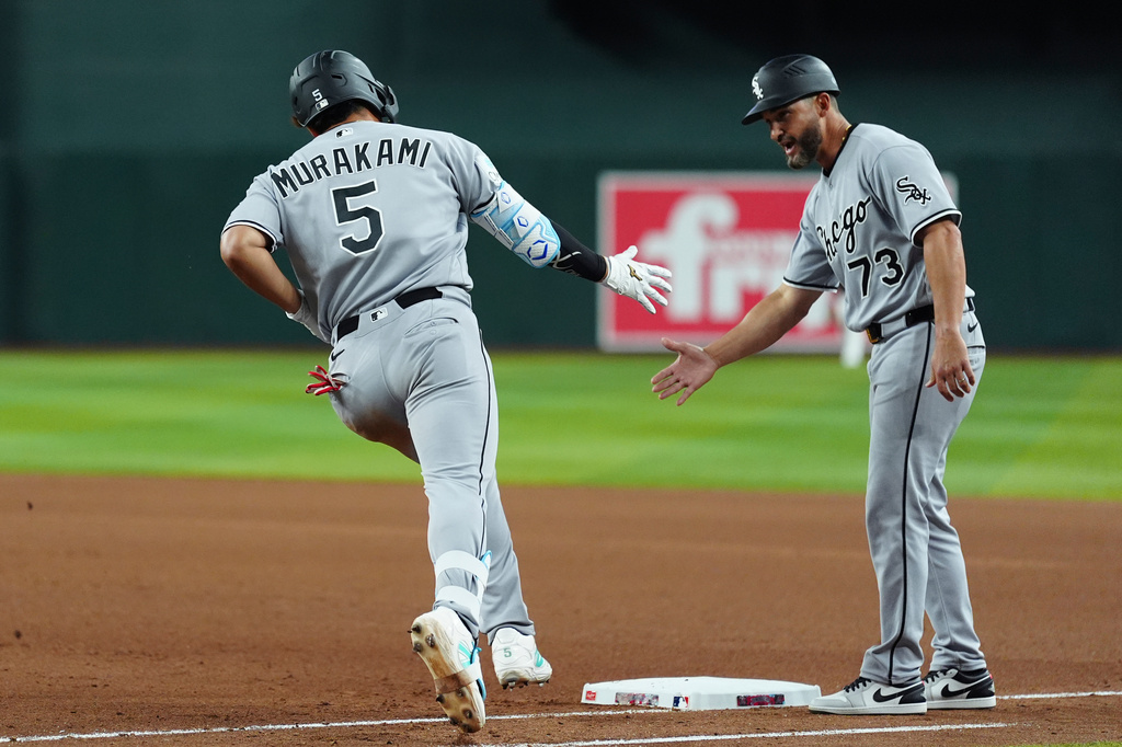 Chicago White Sox's Munetaka Murakami (5), of Japan, celebrates his two-run home run against the Arizona Diamondbacks with White Sox third base coach Jose Leger (73) during the seventh inning of a baseball game, Wednesday, April 22, 2026, in Phoenix. (AP Photo/Ross D. Franklin)