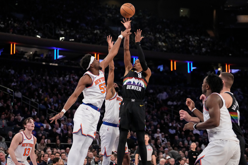 Denver Nuggets guard Peyton Watson (8) shoot over New York Knicks center Ariel Hukporti (55) during the first half of an NBA basketball game, Wednesday, Feb. 4, 2026, in New York. (AP Photo/Yuki Iwamura)
