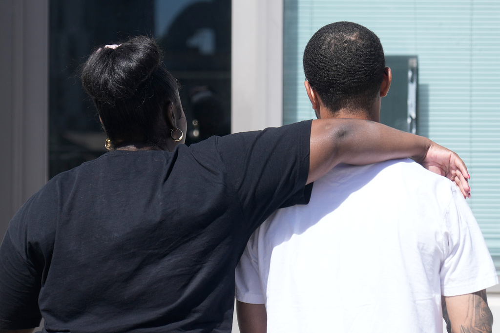 Oakland Ceasefire-Lifeline life coach LaSasha Long, left, puts her arm around Bernard C. during an interview Thursday, April 23, 2026, in Oakland, Calif. (AP Photo/Jeff Chiu)