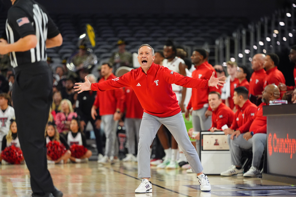Texas Tech head coach Grant McCasland, center, yells during the first half of an NCAA college basketball game against LSU, Sunday, Dec. 7, 2025, in Fort Worth, Texas. (AP Photo/LM Otero)