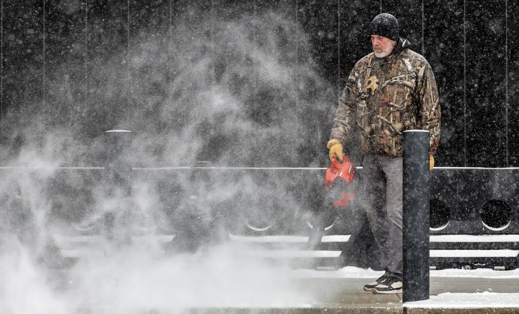 Allen Herzog, director of facilities at the Owensboro Convention Center, blows snow off the loading dock of the facility as a winter storm passes though the area Saturday, Jan. 24, 2026, in Owensboro, Ky. (Greg Eans/The Messenger-Inquirer via AP)