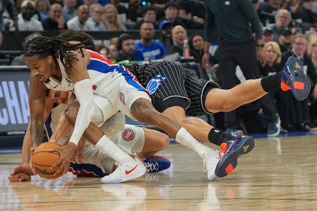Detroit Pistons guard Daniss Jenkins, left, fights for a loose ball with Orlando Magic forward Tristan da Silva during the second half in Game 6 of a first-round NBA basketball playoffs series, Friday, May 1, 2026, in Orlando, Fla. (AP Photo/John Raoux)