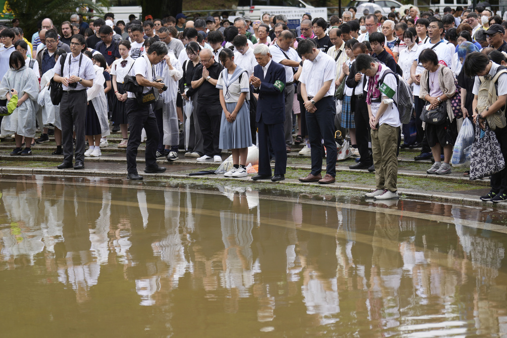 People observe a minute of silence at the Atomic Bomb Hypocenter Park, during a ceremony to commemorate the 80th anniversary of the day an atomic bomb was dropped on Japanese southwestern city, in Nagasaki, Japan Saturday, Aug. 9, 2025.(AP Photo/Eugene Hoshiko)