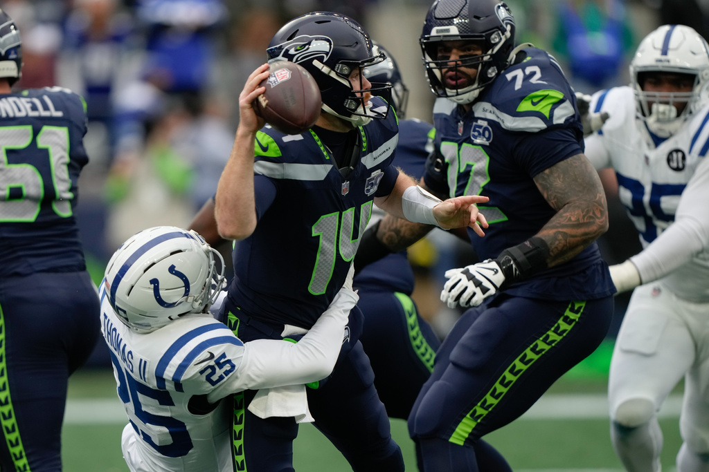 Seattle Seahawks quarterback Sam Darnold (14) tries to throw under pressure from Indianapolis Colts safety Rodney Thomas II (25) during the first half of an NFL football game Sunday, Dec. 14, 2025, in Seattle. (AP Photo/Stephen Brashear)
