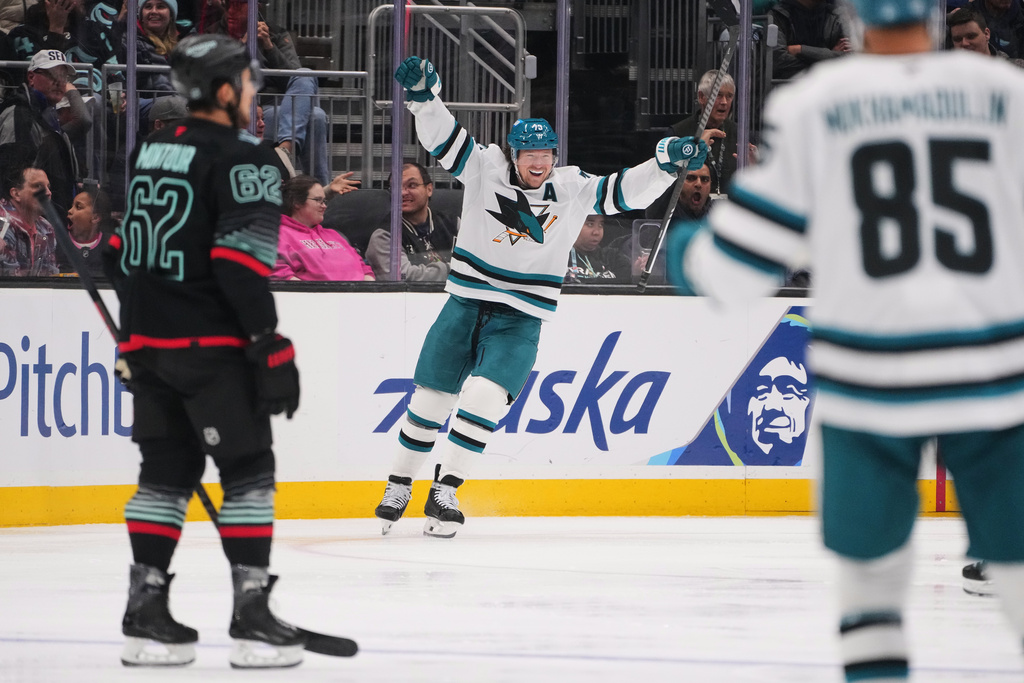 San Jose Sharks center Tyler Toffoli (73) celebrates after scoring as Seattle Kraken defenseman Brandon Montour (62) looks on during the third period of an NHL hockey game Wednesday, Nov. 5, 2025, in Seattle. (AP Photo/Lindsey Wasson)