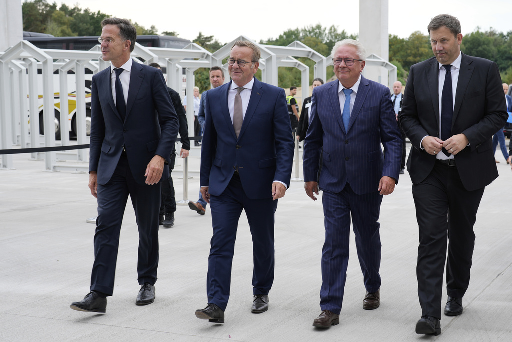 NATO Secretary General Mark Rutte, from left, German Defense Minister Boris Pistorius, CEO Armin Papperger and German Vice Chancellor Lars Klingbeil arrive for the inauguration of the newly built artillery ammunition plant by German arms manufacturer Rheinmetall in Unterluess, Germany, Wednesday, Aug. 27, 2025. (AP Photo/Markus Schreiber)