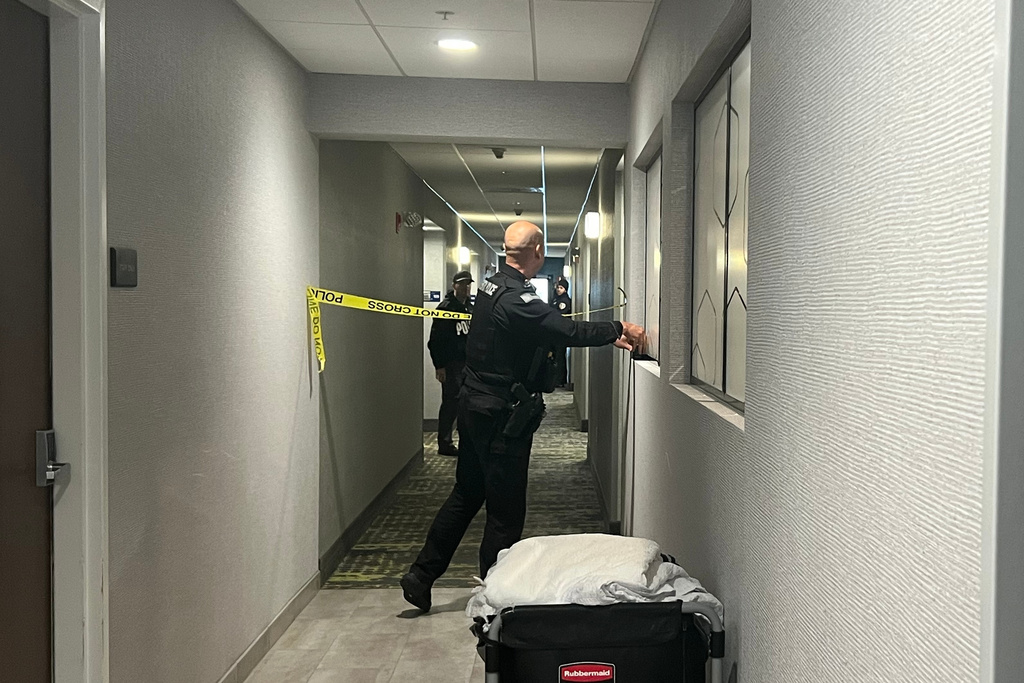 Police tape off hotel rooms where the person of interest was arrested in a shooting, Sunday, Dec. 14, 2025, in Coventry, R.I. (AP Photo/Kimberlee Kruesi)