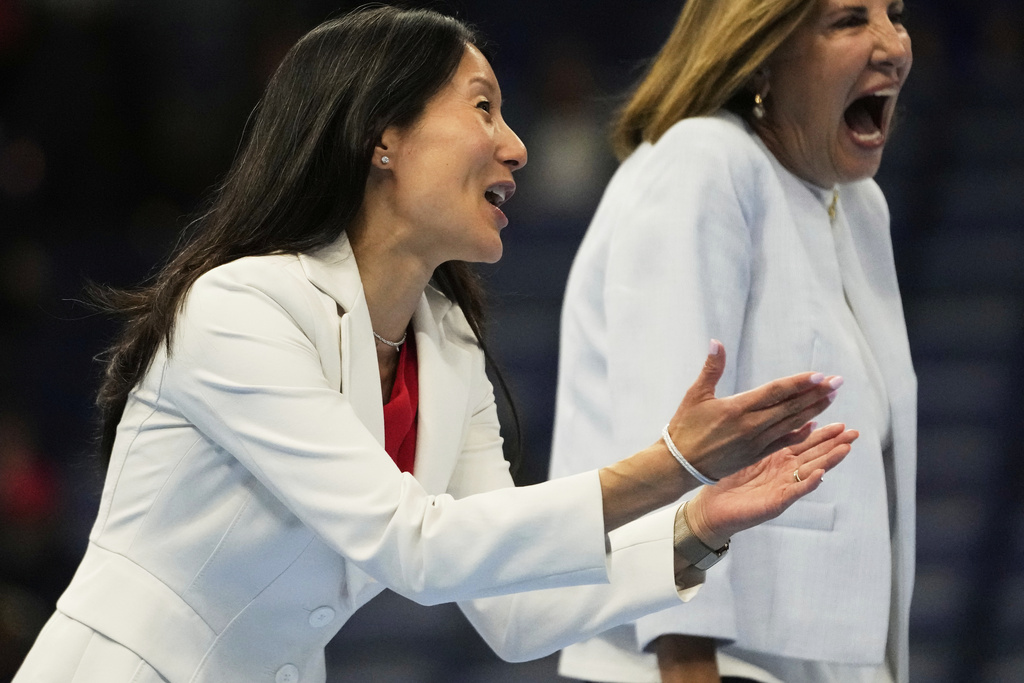 USA Gymnastics president Li Li Leung walks on stage after the senior men's finals of the U.S. Gymnastics Championships in New Orleans, Saturday, Aug. 9, 2025. (AP Photo/Gerald Herbert)