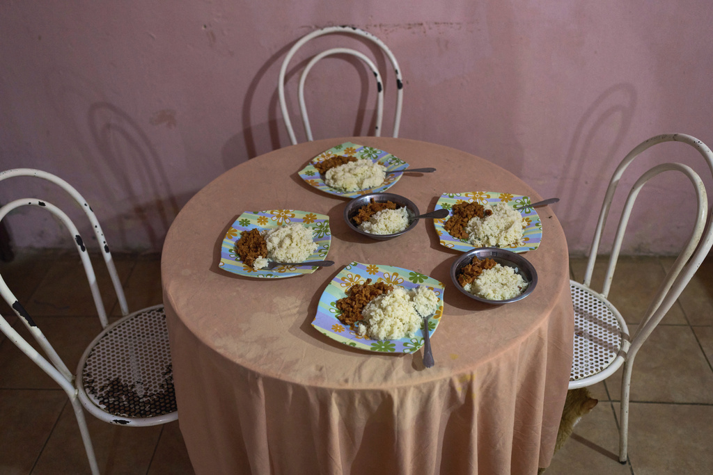 Plates of food are set on the dinner table at Alnily Chirino's home, before she eats with her four children and grandson in Coro, Venezuela, Friday, June 27, 2025. (AP Photo/Ariana Cubillos)