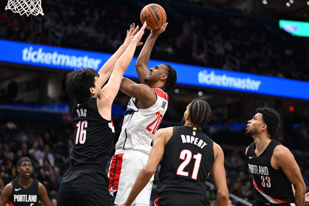 Washington Wizards center Alex Sarr goes to shoot over Portland Trail Blazers center Yang Hansen (16) during the first half of an NBA basketball game, Tuesday, Jan. 27, 2026, in Washington. (AP Photo/John McDonnell)