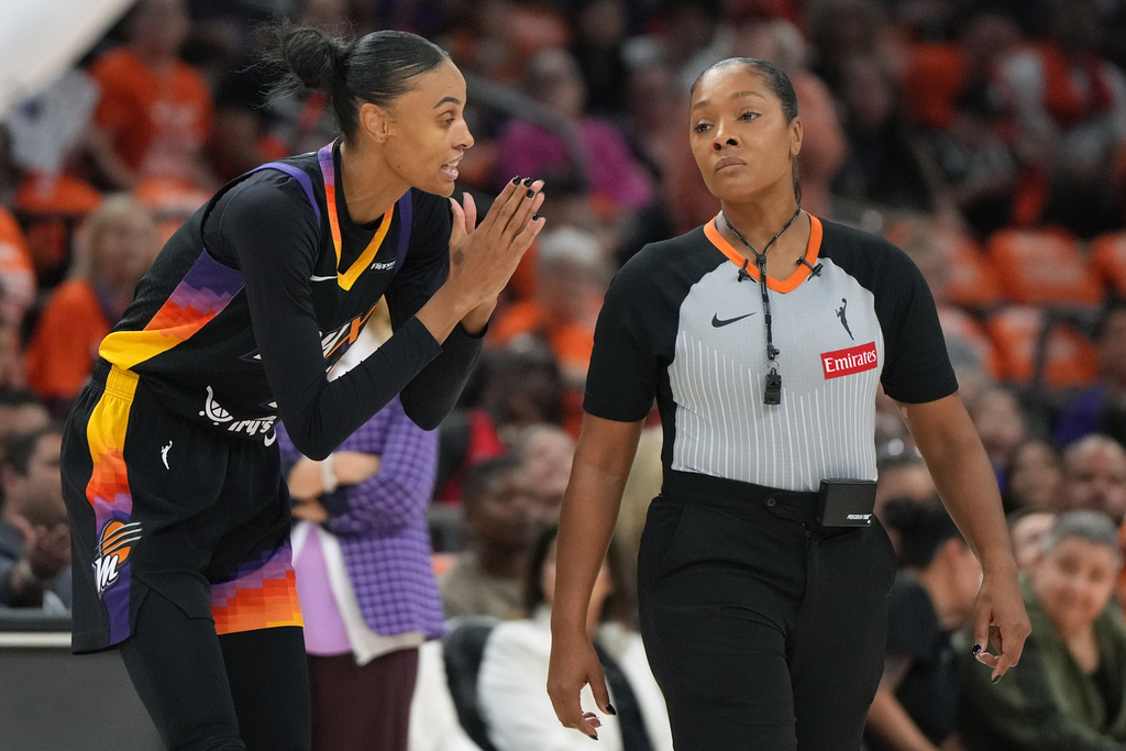 Phoenix Mercury forward DeWanna Bonner (14) talks to WNBA official Fatou Cissoko-Stephens during the first half of Game 3 of the WNBA basketball finals against the Las Vegas Aces, Wednesday, Oct. 8, 2025, in Phoenix. (AP Photo/Rick Scuteri)