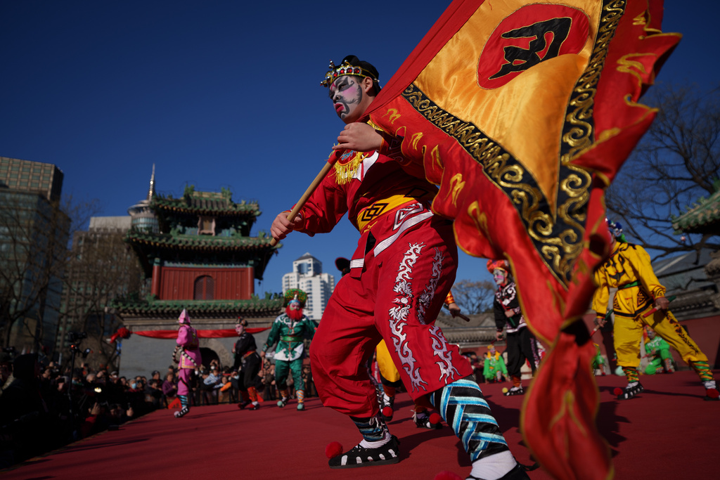 Dancers in colorful costumes perform Yingge Dance, a traditional folk dance from southern China during Lunar New Year celebrations in Beijing, China, Tuesday, Feb. 17, 2026. (AP Photo/Vincent Thian)