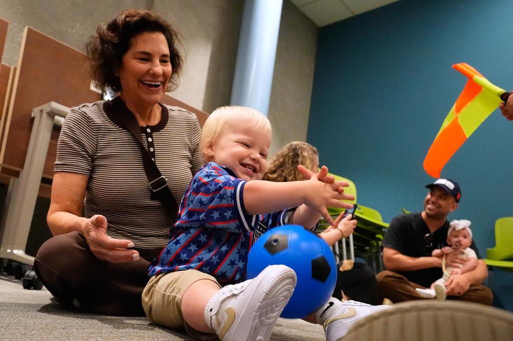 Briggs Graham, age 1, plays with a soccer ball at a program introducing toddlers to the sport ahead of the World Cup soccer tournament Thursday, June 4, 2026, in Lenexa, Kan. (AP Photo/Charlie Riedel)