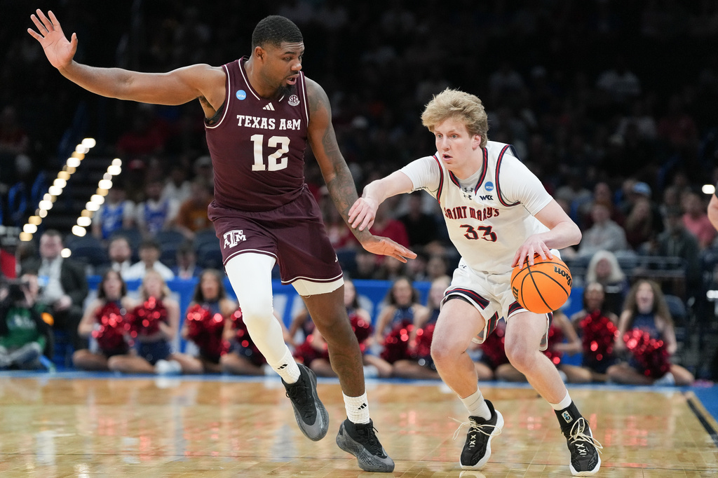 Saint Mary's guard Liam Campbell (33) pushes past Texas A&M forward Rashaun Agee (12) during the first half in the first round of the NCAA college basketball tournament, Thursday, March 19, 2026, in Oklahoma City. (AP Photo/Kyle Phillips)