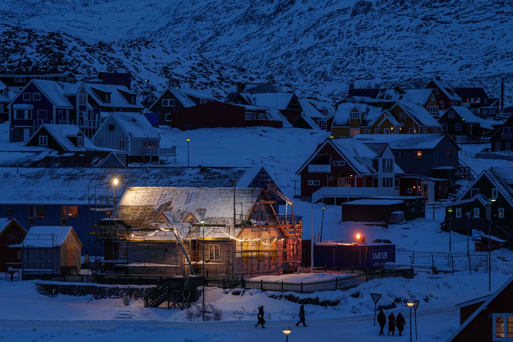 People walk along a street in downtown of Nuuk, Greenland, on Tuesday, Jan. 13, 2026. (AP Photo/Evgeniy Maloletka)