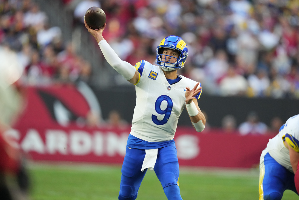 Los Angeles Rams quarterback Matthew Stafford passes the ball in the first half of an NFL football game against the Arizona Cardinals, Sunday, Dec. 7, 2025, in Glendale, Ariz. (AP Photo/Ross D. Franklin)