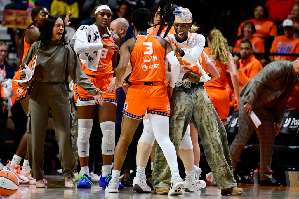 Connecticut Sun's Saniya Rivers, right, greets Connecticut Sun guard Ashlon Jackson at a time out in the first half of a WNBA basketball game against the Toronto Tempo, Thursday, Sept. 24, 2026, in Uncasville, Conn. (AP Photo/Jessica Hill)