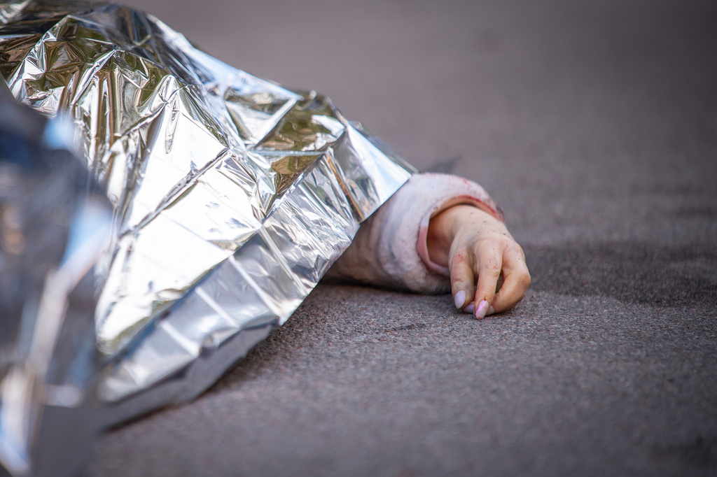 The body of victim is seen at the site where a gunman killed at least six people in the streets before being shot dead by police, in Kyiv, Ukraine, Saturday, April 18, 2026. (AP Photo/Dan Bashakov)