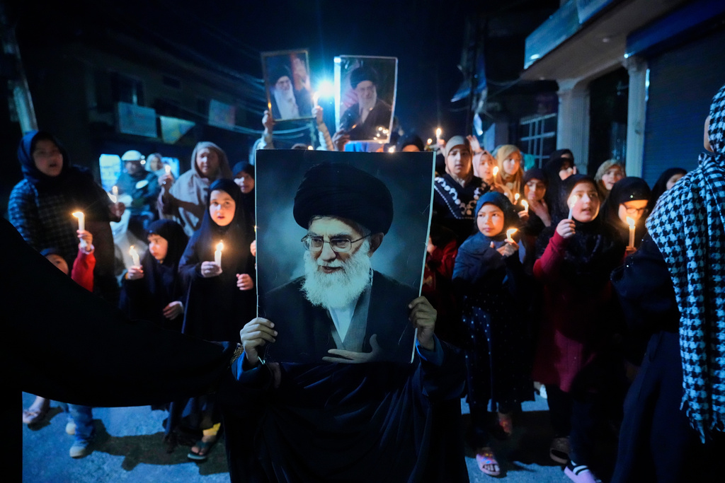 Shiite Muslims shout slogans during a candlelit protest against the killing of Iran's Supreme Leader Ayatollah Ali Khamenei, in Srinagar, Indian controlled Kashmir, Wednesday, March 4, 2026. (AP Photo/Mukhtar Khan)