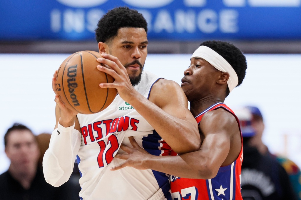 Detroit Pistons forward Tobias Harris (12) drives against Philadelphia 76ers guard Vj Edgecombe (77) during the first half of an NBA basketball game, Thursday, March 12, 2026, in Detroit. (AP Photo/Duane Burleson)